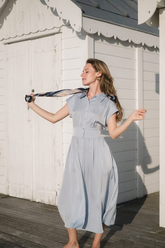 a lady wears a light blue silk maxi dress